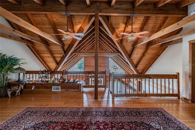 interior space featuring a ceiling fan, light wood-type flooring, wood ceiling, and vaulted ceiling with beams