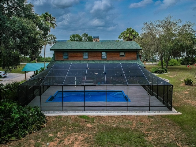 pool featuring a lanai and a lawn