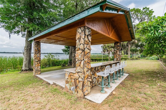 exterior space featuring a water view and outdoor dry bar