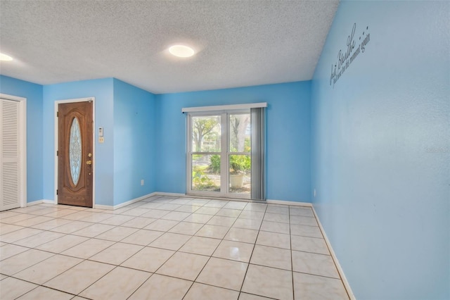 tiled spare room with a textured ceiling