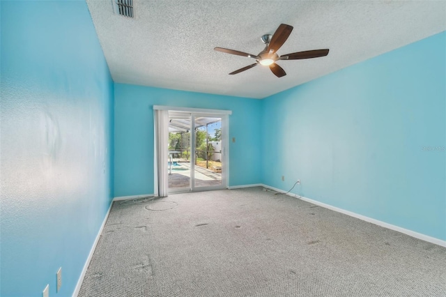 carpeted empty room with ceiling fan and a textured ceiling