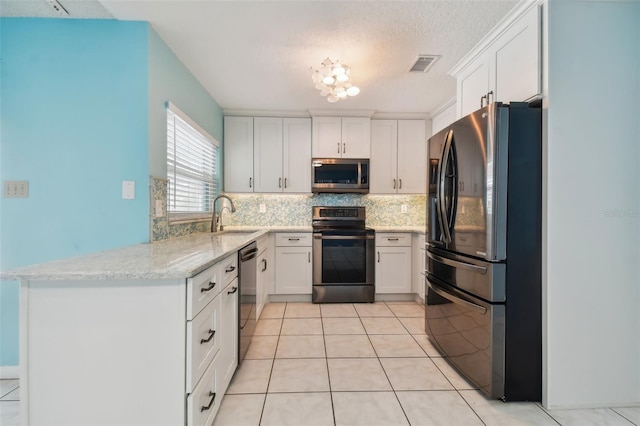 kitchen with sink, light stone countertops, appliances with stainless steel finishes, and white cabinets