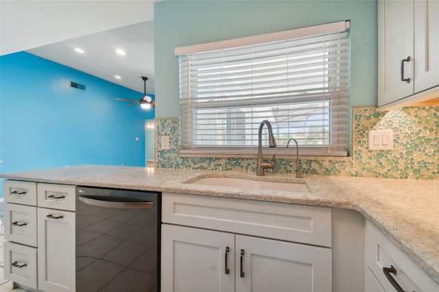 kitchen with light stone countertops, dishwasher, sink, decorative backsplash, and white cabinets