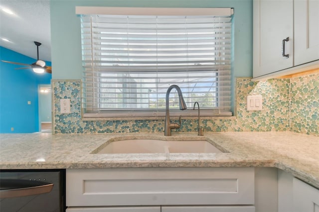 room details featuring dishwasher, sink, white cabinetry, ceiling fan, and light stone counters