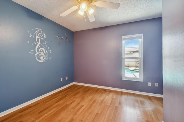 unfurnished room featuring a textured ceiling, hardwood / wood-style flooring, and ceiling fan