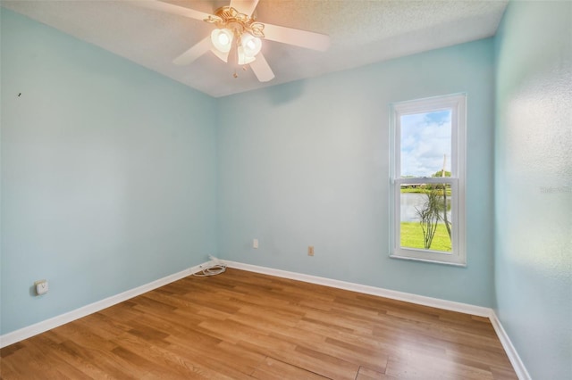 unfurnished room with a textured ceiling, hardwood / wood-style floors, and ceiling fan