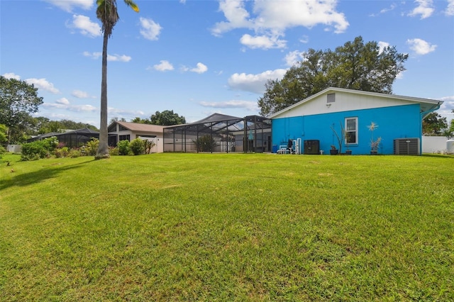 view of yard featuring central AC and a lanai