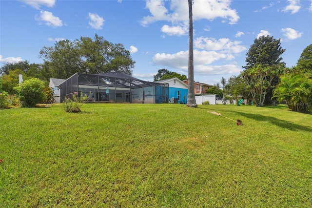 view of yard with glass enclosure