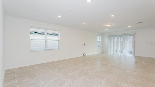 spare room featuring light tile patterned floors