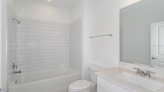 full bathroom featuring vanity, tiled shower / bath combo, and toilet