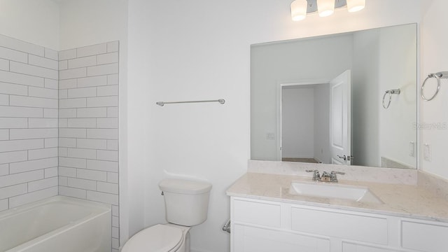 full bathroom featuring tiled shower / bath, vanity, and toilet