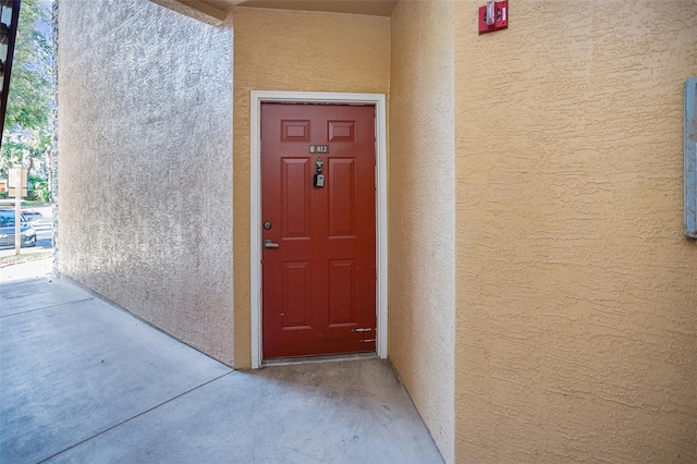 view of exterior entry with stucco siding