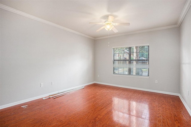 spare room with ceiling fan, crown molding, and wood-type flooring