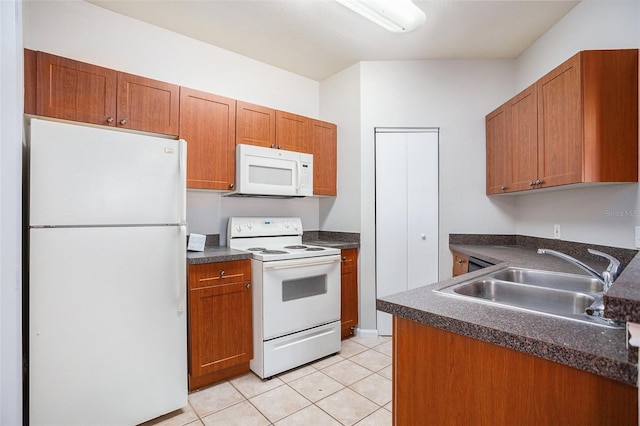 kitchen with light tile patterned flooring, sink, and white appliances