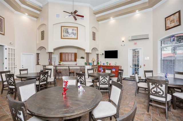 dining room featuring french doors, crown molding, high vaulted ceiling, ceiling fan, and a wall unit AC