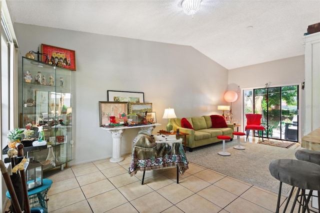 tiled living room featuring a textured ceiling and lofted ceiling