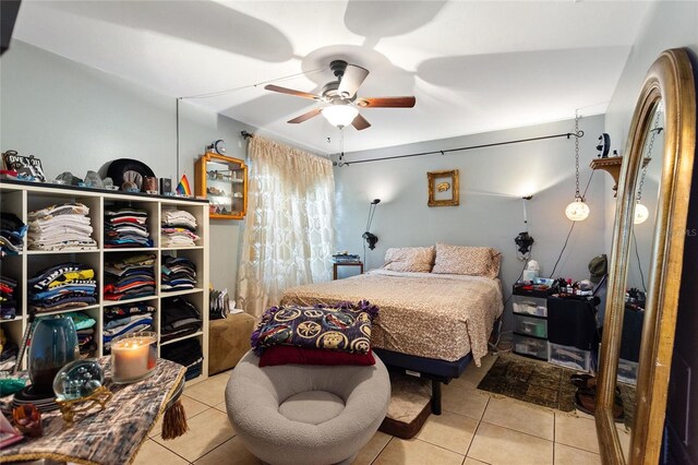 tiled bedroom with ceiling fan