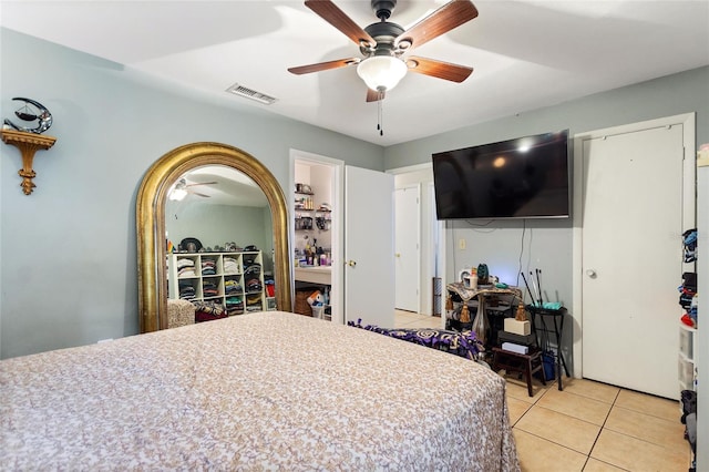 tiled bedroom with ceiling fan