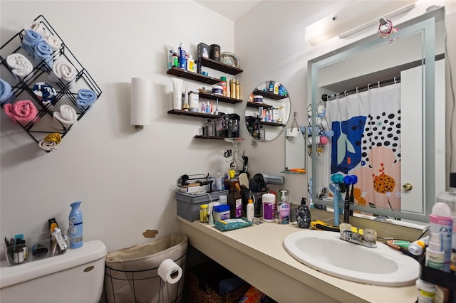 bathroom featuring toilet and vanity