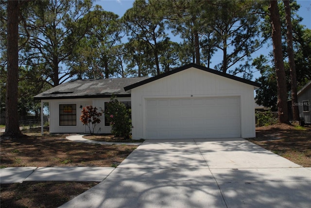 ranch-style house with a garage, concrete driveway, a shingled roof, and fence