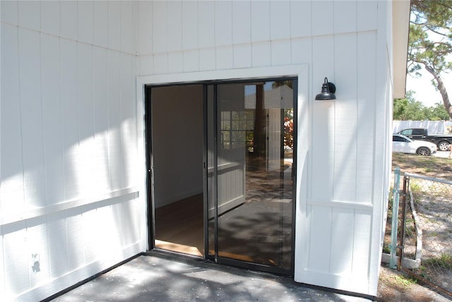 view of exterior entry featuring fence