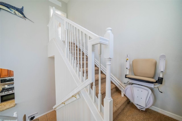stairway featuring baseboards