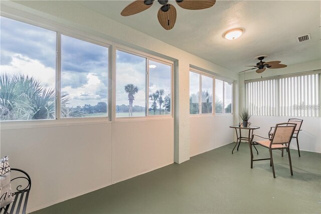 sunroom / solarium with visible vents and a ceiling fan
