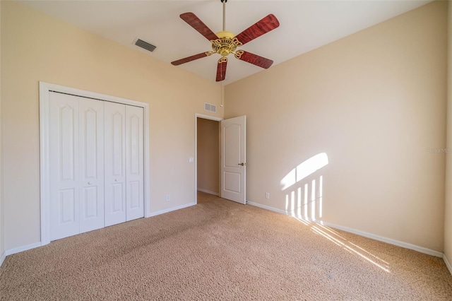 unfurnished bedroom with carpet floors, a closet, and ceiling fan