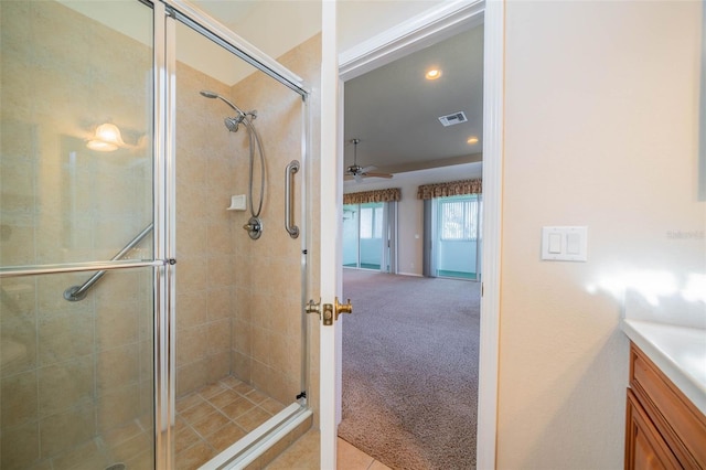 full bath with a stall shower, visible vents, ceiling fan, and vanity