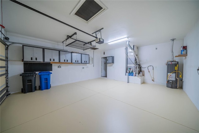 garage with a garage door opener and gas water heater