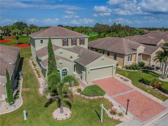 view of front of house featuring a garage, fence, decorative driveway, and stucco siding