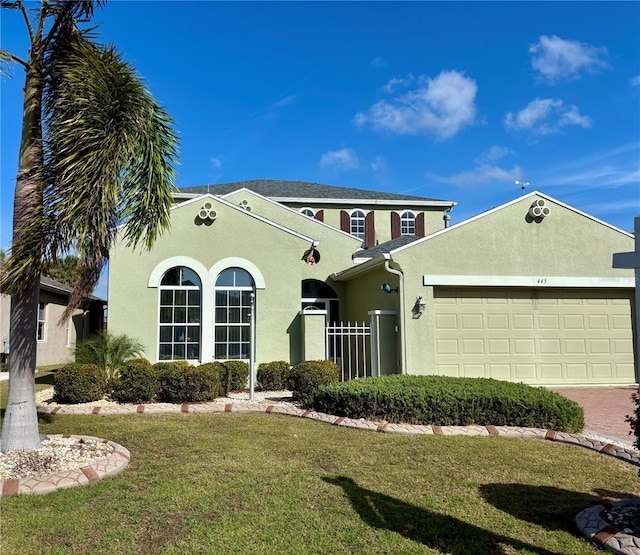 view of front of home featuring a front lawn, decorative driveway, an attached garage, and stucco siding