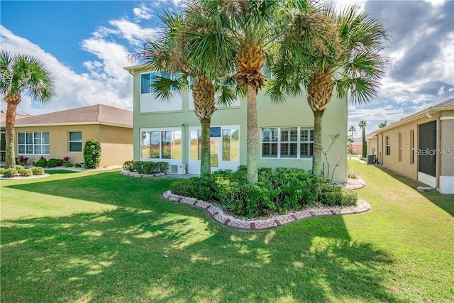 rear view of property with a yard