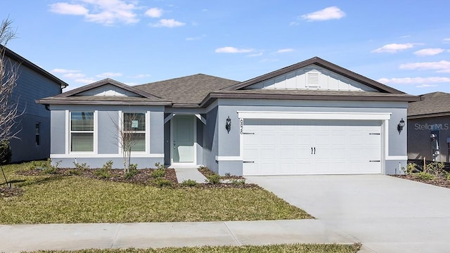 ranch-style home featuring a garage and a front lawn