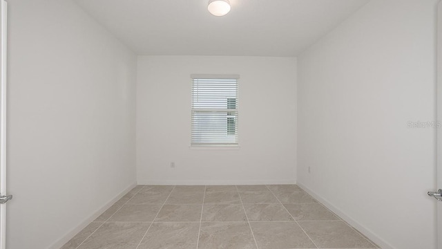 spare room with light tile patterned flooring