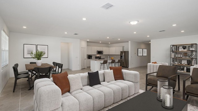 living room with sink and light tile patterned flooring