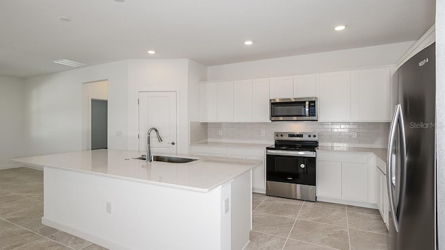 kitchen featuring sink, an island with sink, white cabinets, and appliances with stainless steel finishes