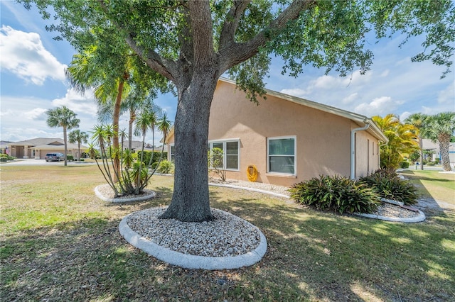 exterior space with a yard and stucco siding