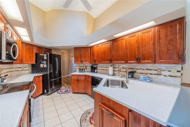 kitchen featuring black appliances, ceiling fan, tasteful backsplash, and sink