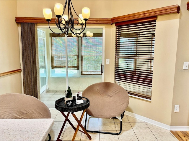 sitting room featuring light tile patterned floors and a notable chandelier