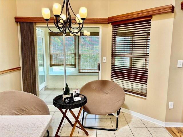 sitting room featuring a chandelier, baseboards, and light tile patterned floors