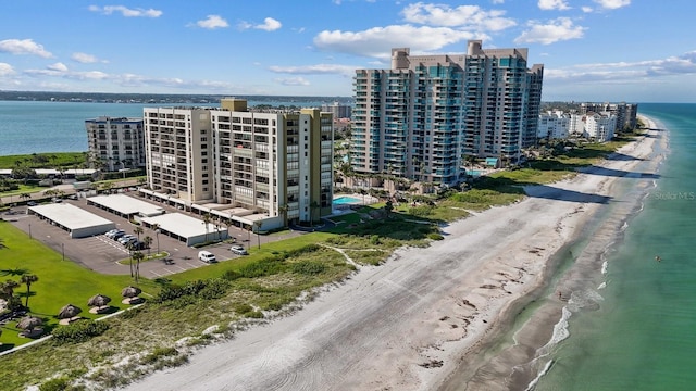 birds eye view of property with a view of the beach and a water view