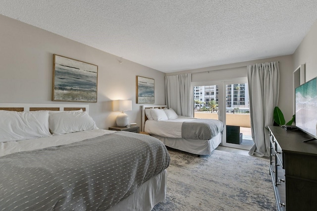 bedroom with access to outside and a textured ceiling