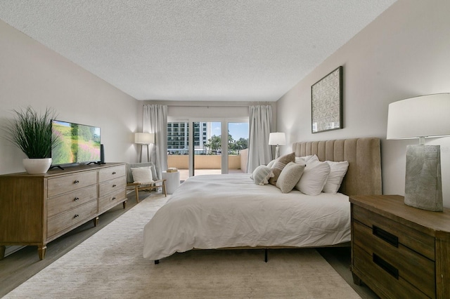 bedroom featuring a textured ceiling and hardwood / wood-style flooring