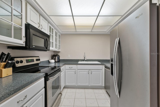 kitchen featuring sink, white cabinets, appliances with stainless steel finishes, and light tile patterned floors