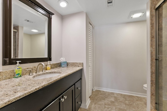 bathroom featuring tile patterned flooring, vanity, and toilet