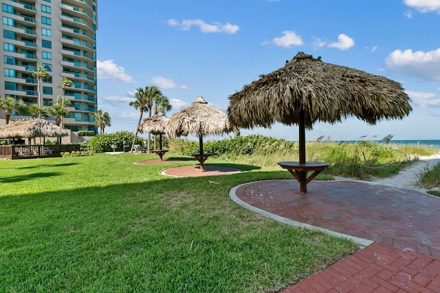 view of property's community featuring a yard, a gazebo, and a water view