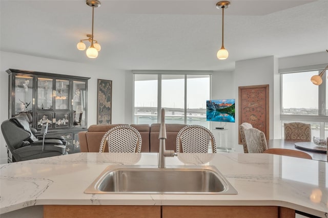 kitchen featuring light countertops, plenty of natural light, and a sink