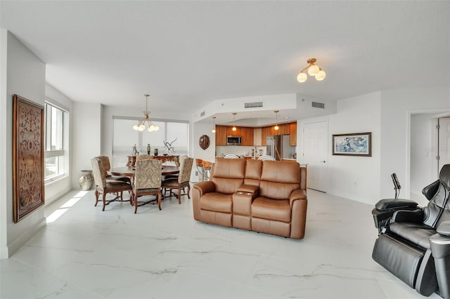 living room with baseboards, marble finish floor, visible vents, and a notable chandelier