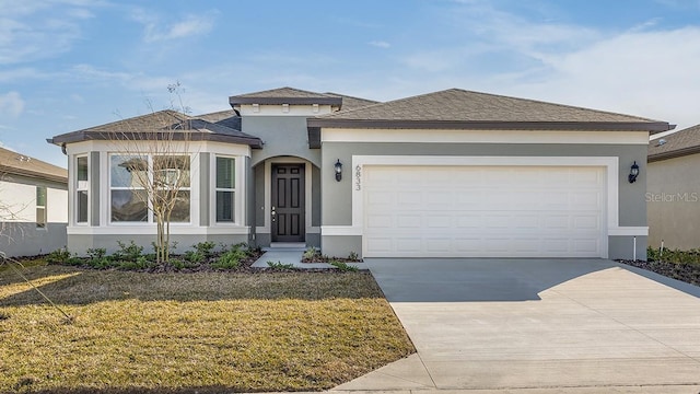 view of front of property featuring a garage and a front lawn